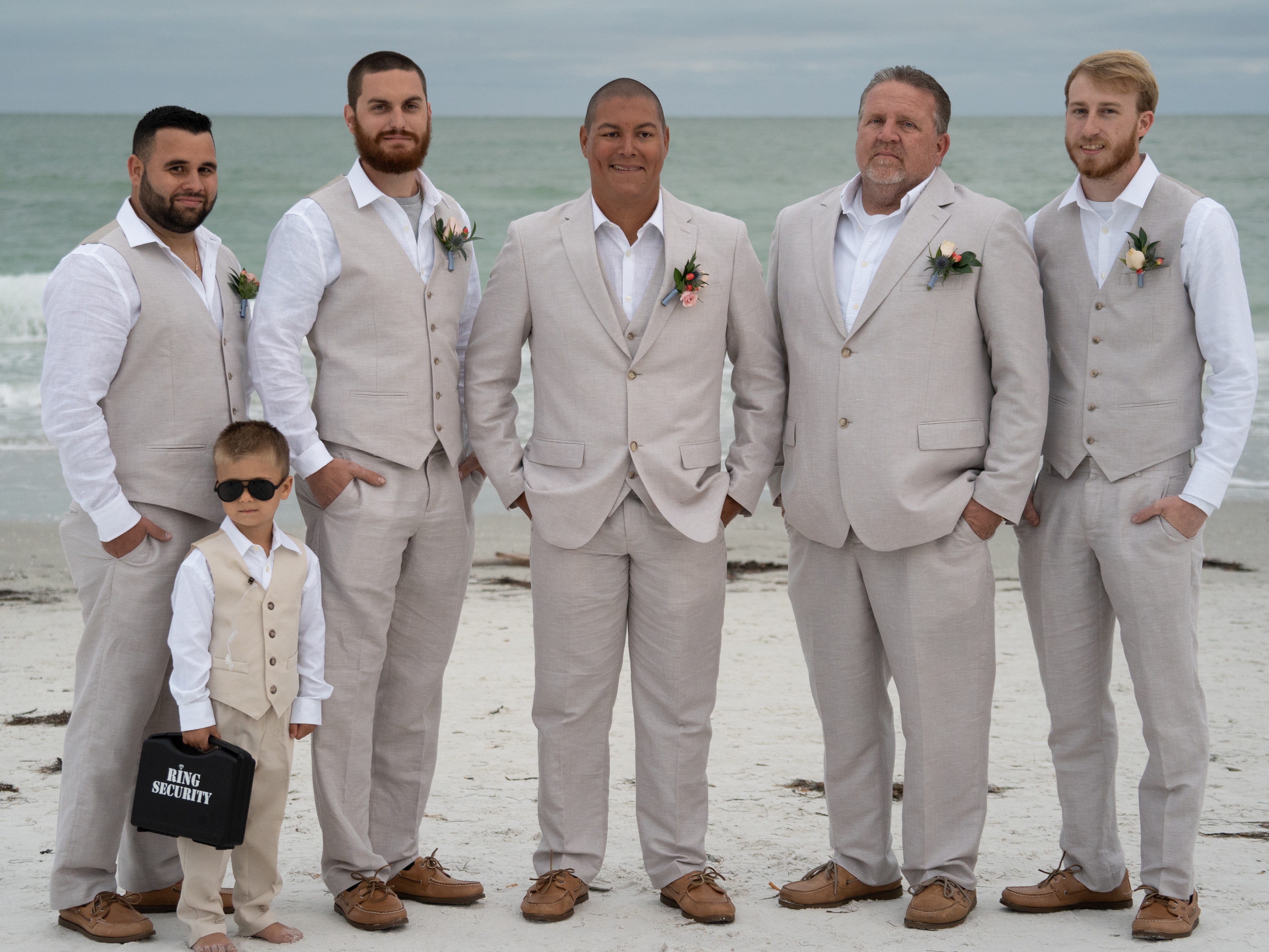 groomsmen in light gray suits for beach wedding