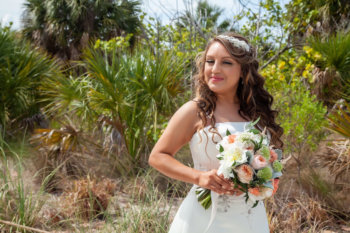 bride in satin wedding gown with rose bridal bouquet 