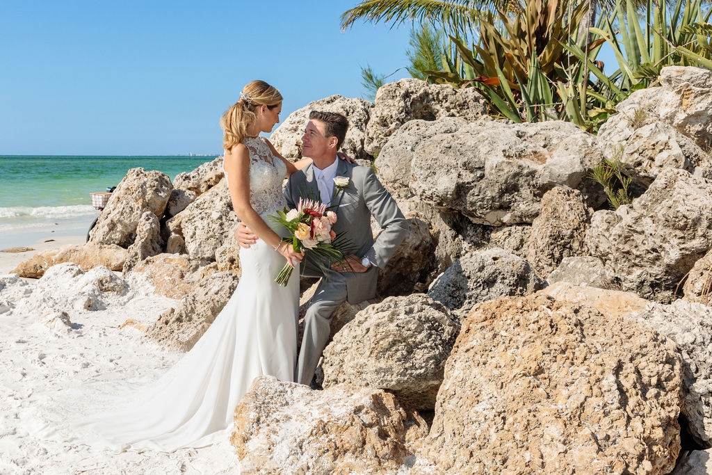 bride and groom portraits on the rocks by the Florida coast