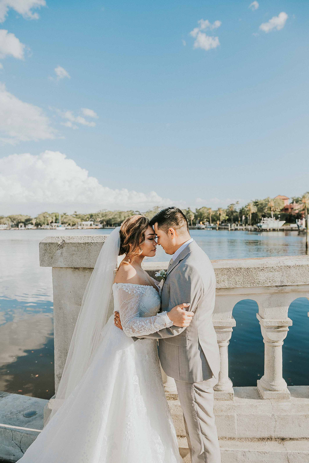 bride and groom next to water in St. Petersburg Florida