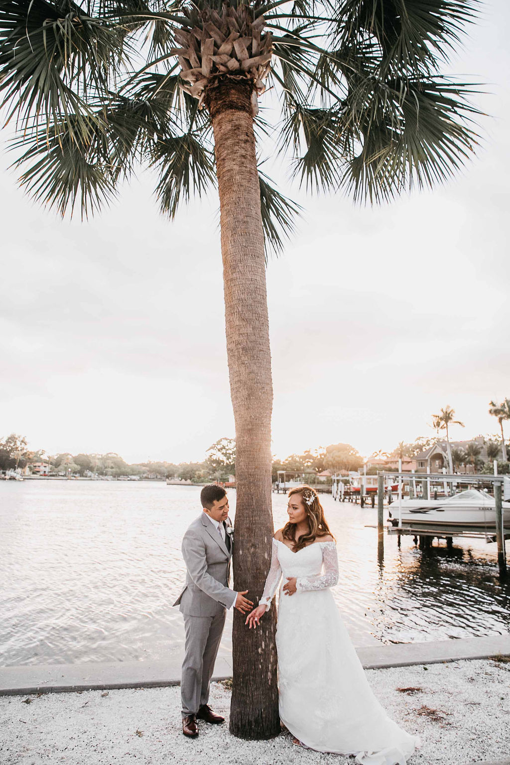 Bride and groom portraits near water by St Pete Woman's Club