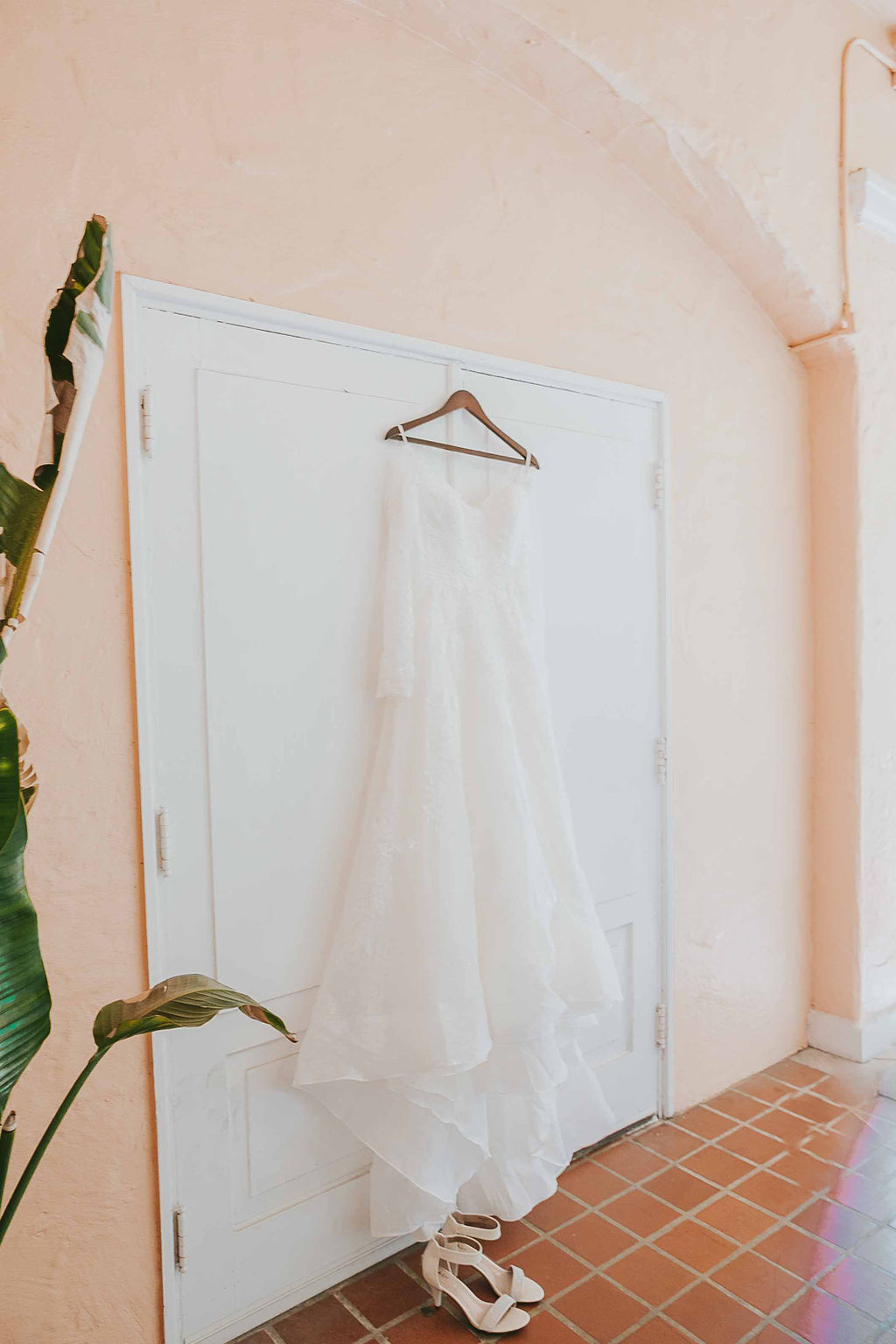 embroidered tulle wedding gown hanging up