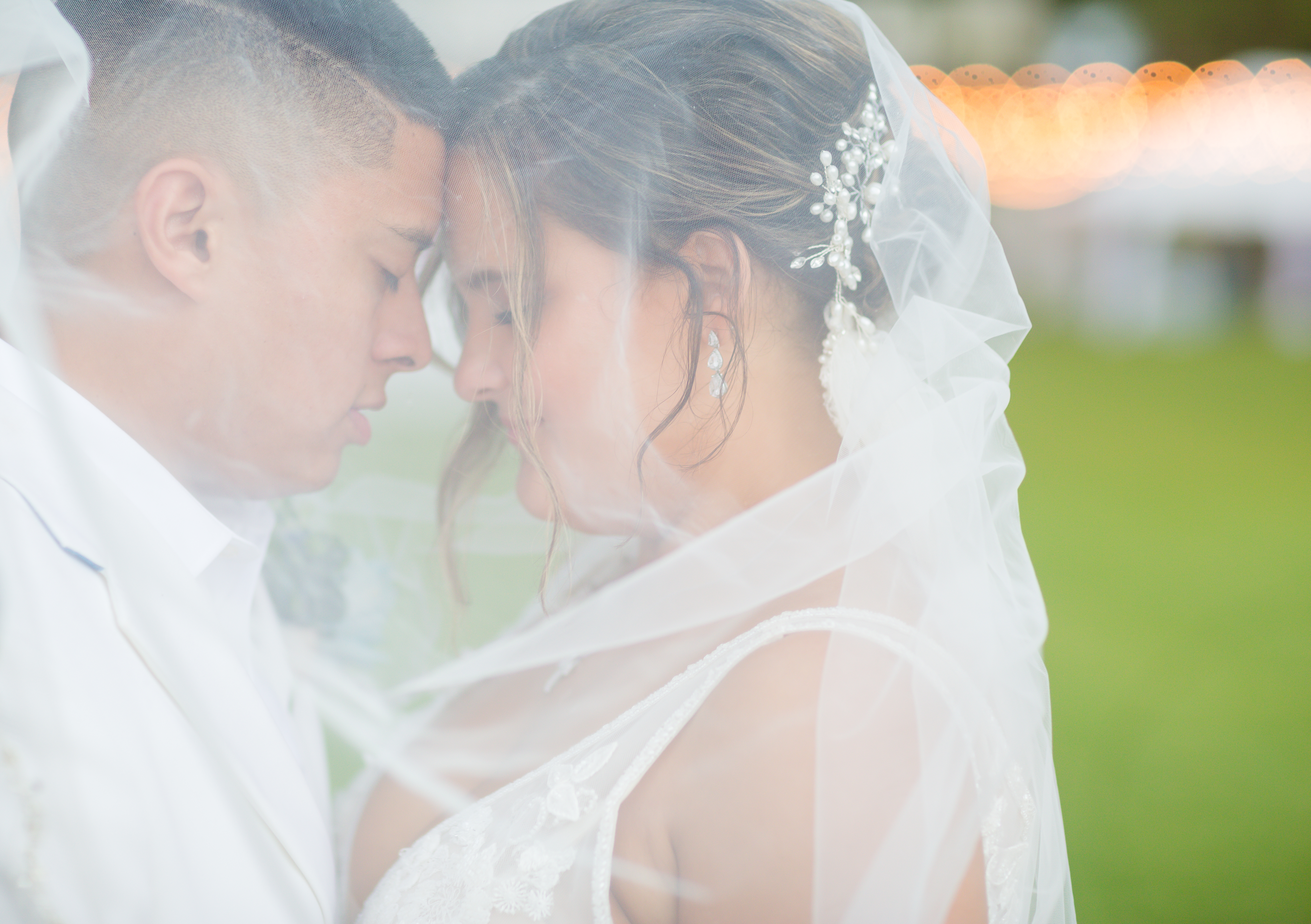 Bride and Groom with veil; White Orchid at Oasis; Precious Moments Events