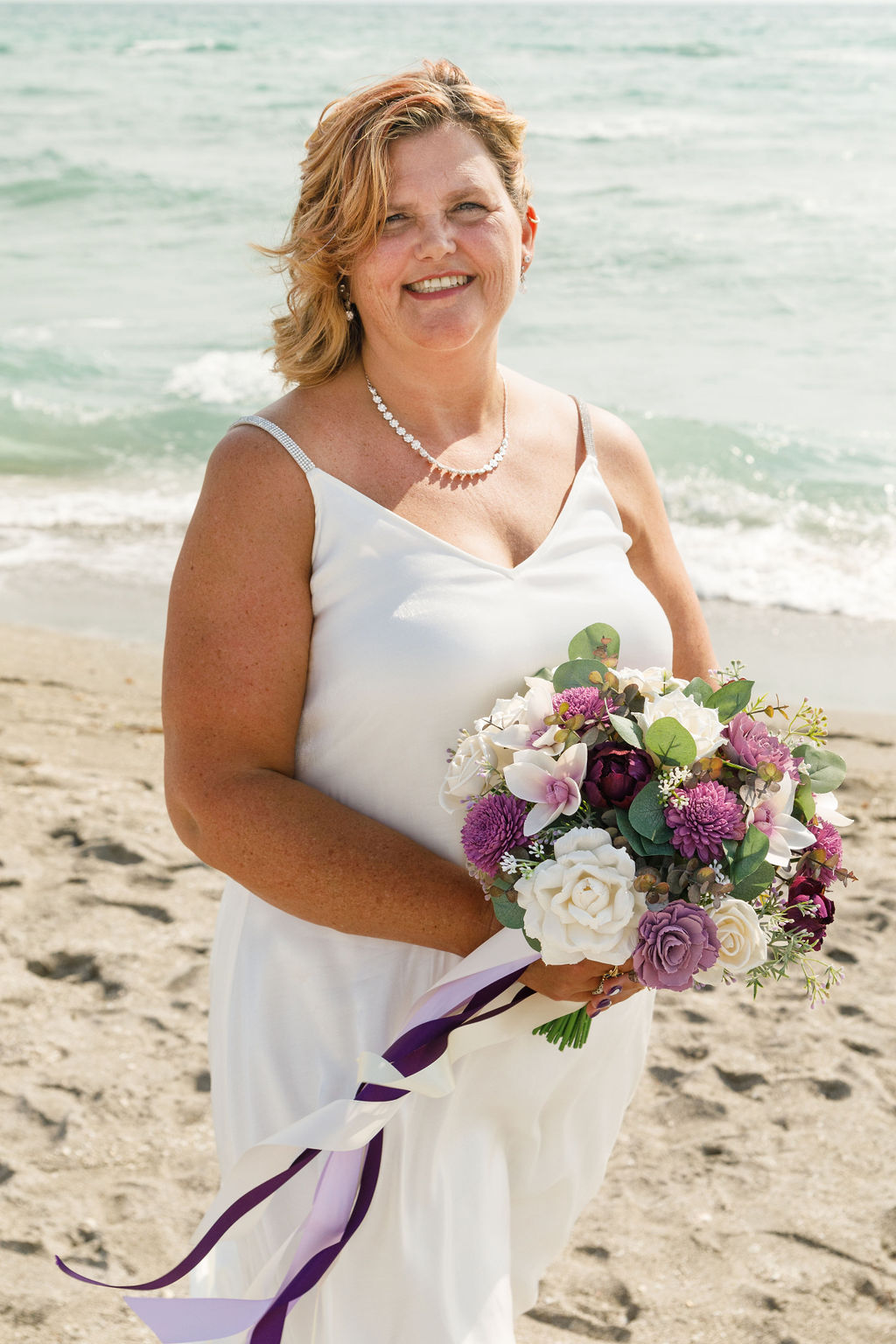 bride in satin wedding gown with colorful bridal bouquet