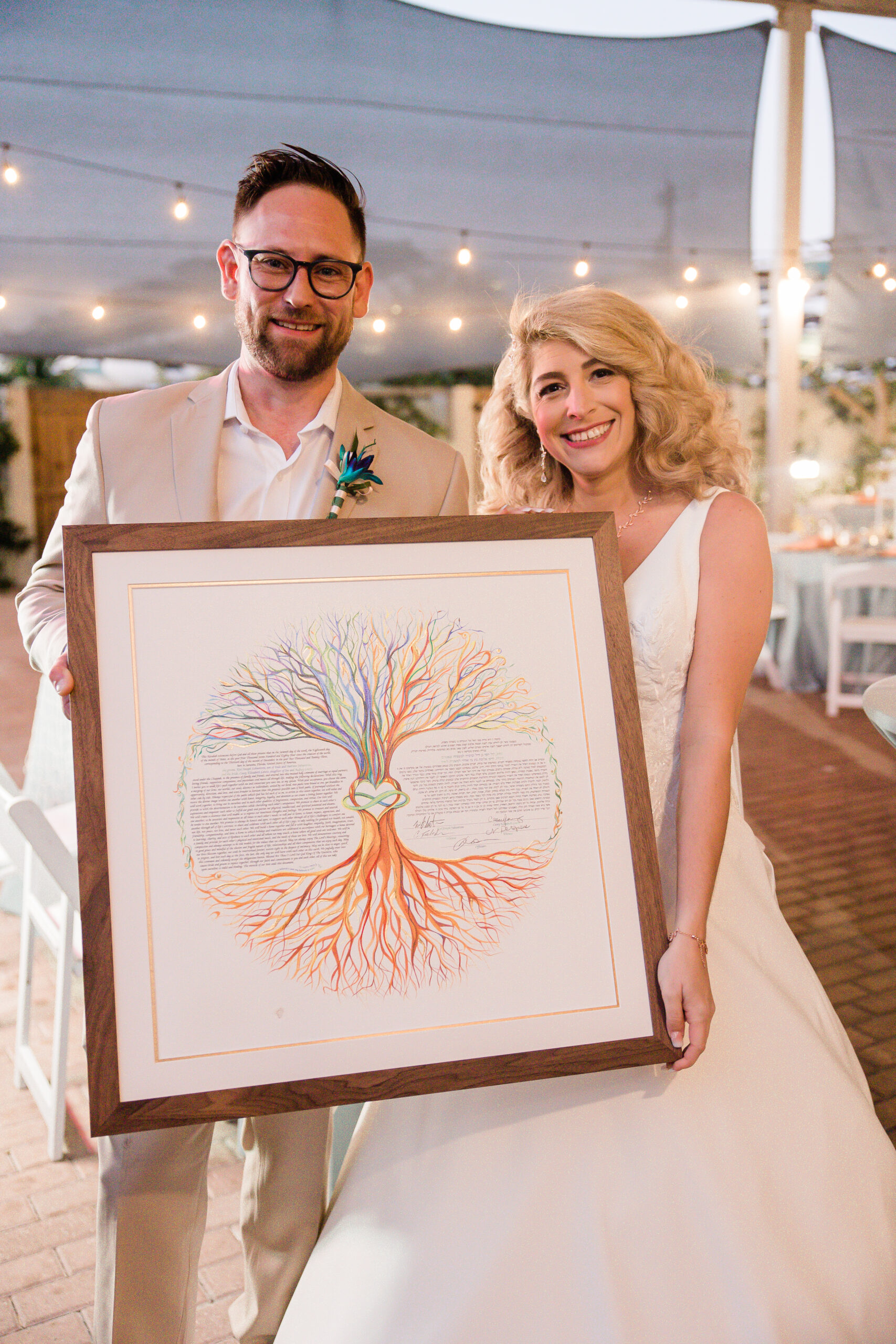 bride and groom with custom wedding certificate 