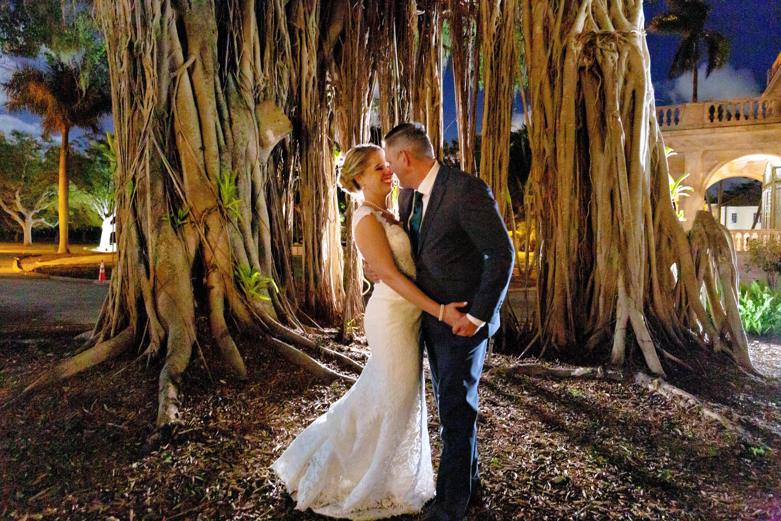 bride and groom next to Strangler Fig at Historical Ringling Mansion, College Hall