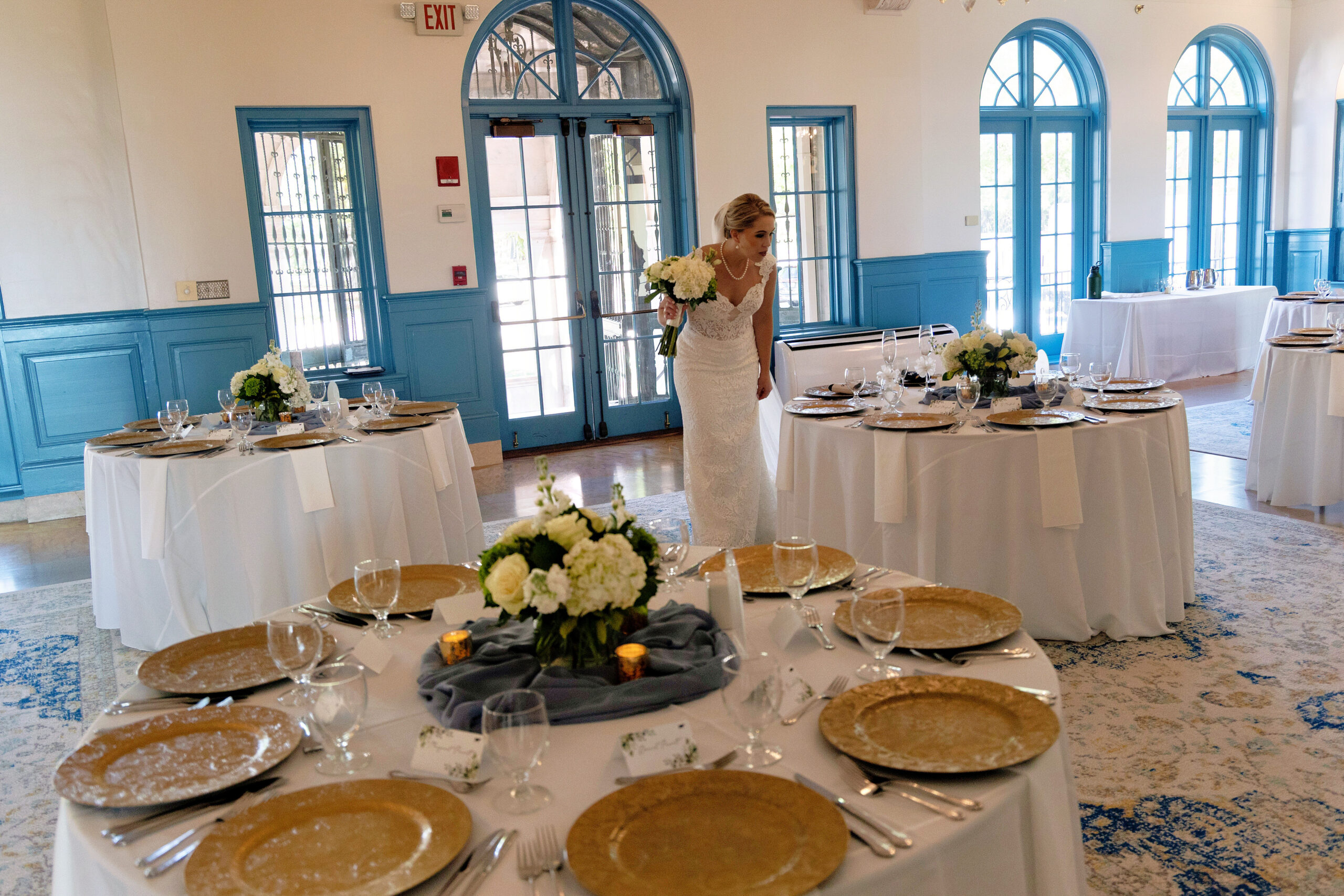 bride looking over her indoor wedding reception at Historical Ringling Mansion, College Hall