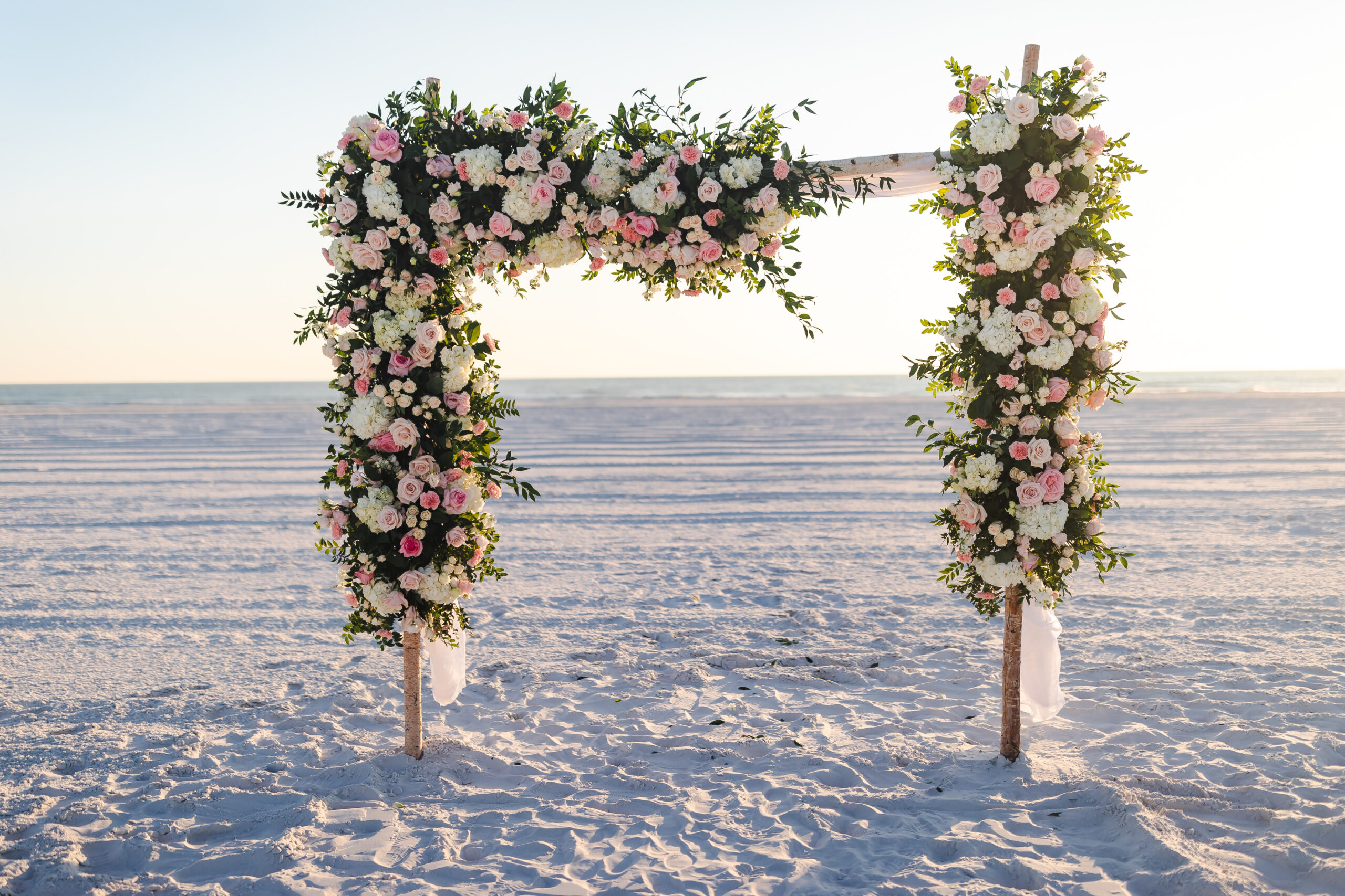 wedding ceremony sign covered in white and pink florals