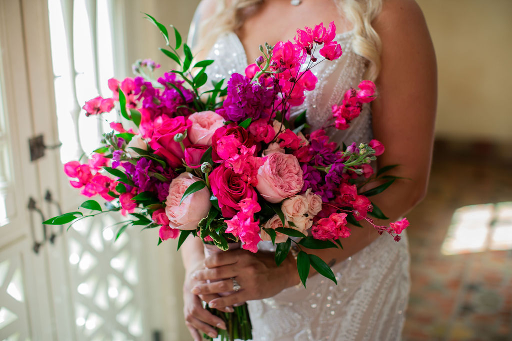 bridal bouquet with pink, red, and purple flowers