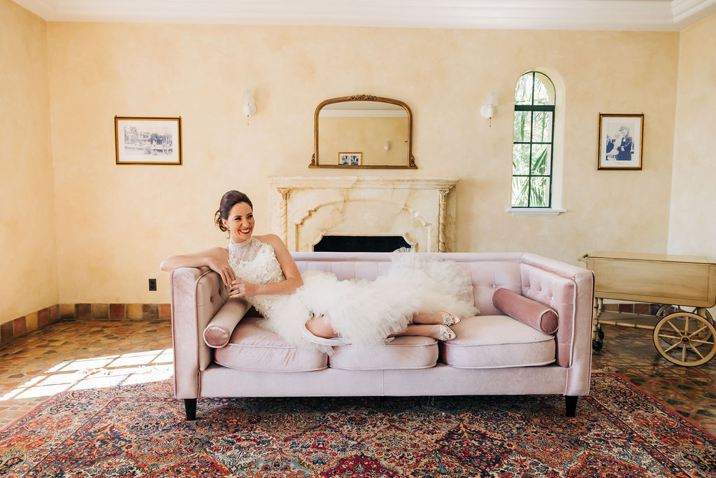 bride laying on a couch in her gown