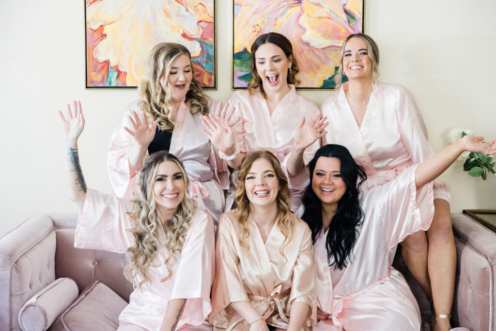 bride and bridesmaids in pink getting ready robes