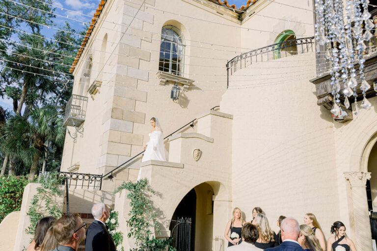 bride coming down the stairs for her wedding ceremony at Powel Crosley Estate