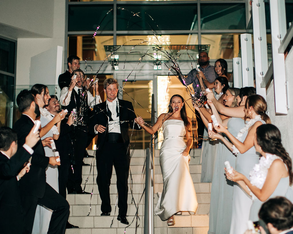 bride and groom exit with confetti poppers