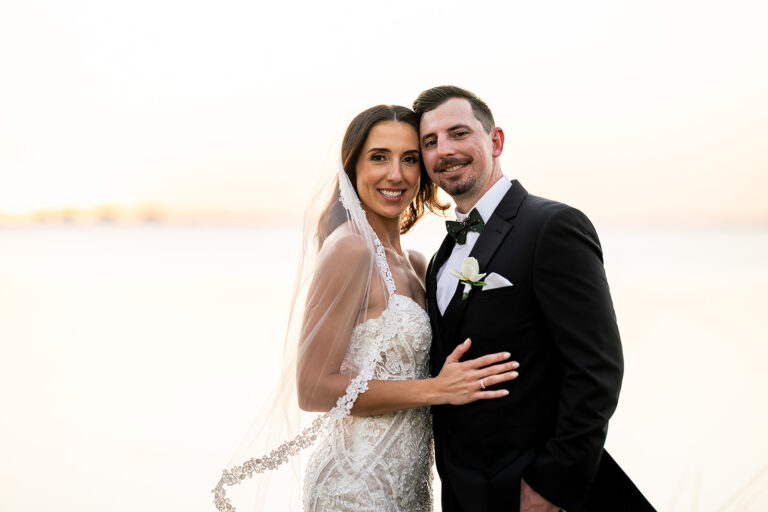 bride in laced gown and groom in black tux