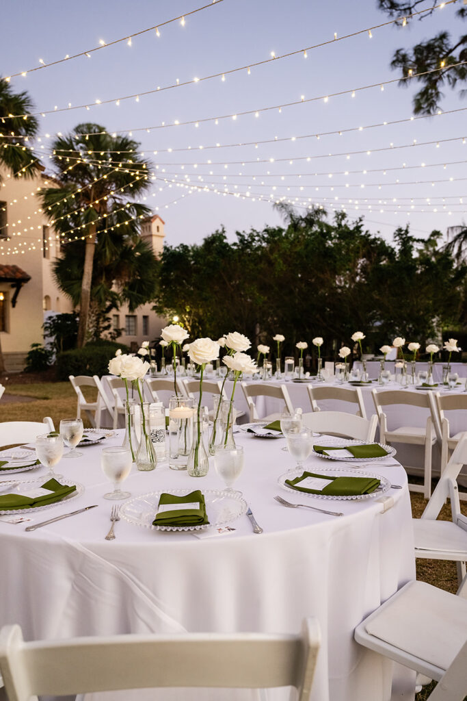 wedding tablescape with white roses and emerald naptkins