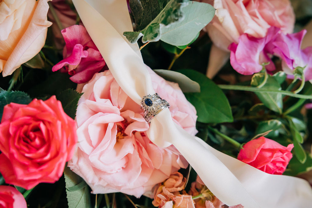 bride's sapphire ring in her colorful bouquet