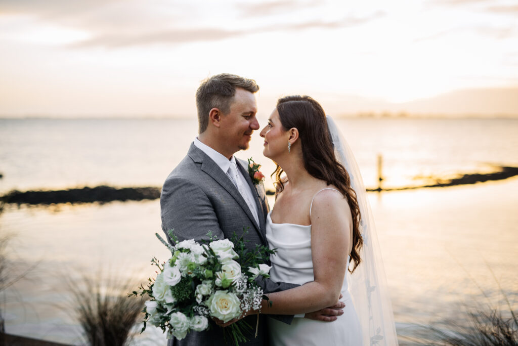 bride in classic wedding gown and groom in gray suit