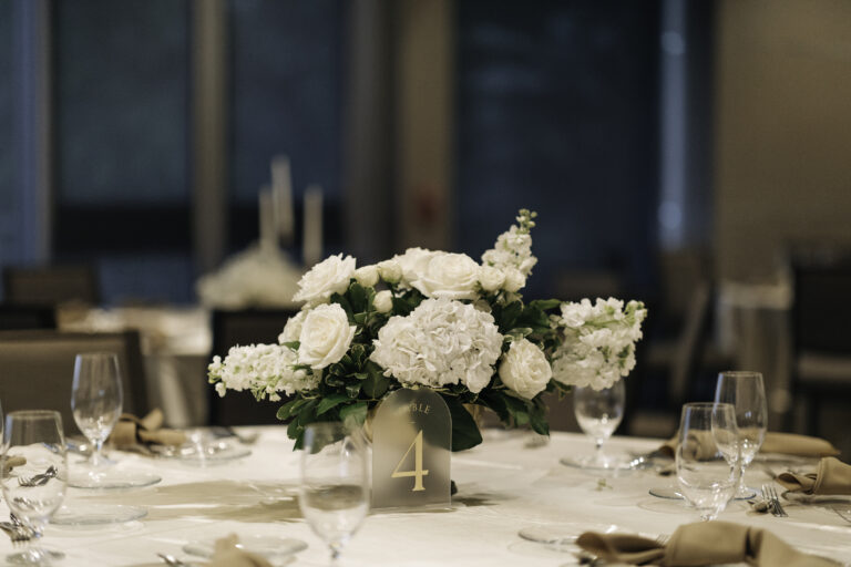 frosted glass table numbers and white floral wedding centerpiece