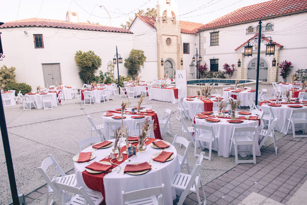 outdoor wedding reception with red details at Bishop Museum of Science by Precious Moments Events