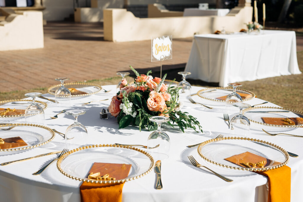 wedding tablescape with orange and gold details