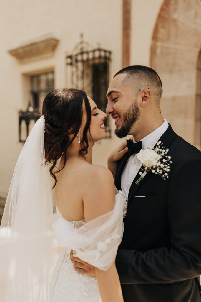 bride in off shoulder lace gown and groom in black tux