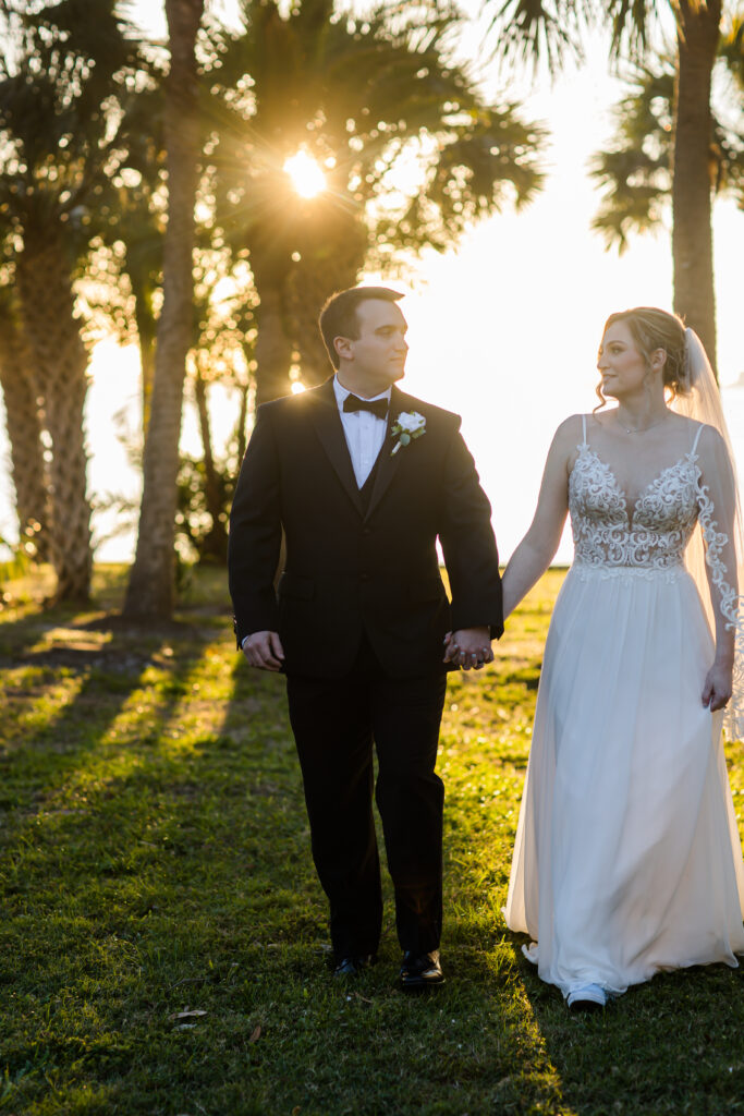 groom in black tux and bride in embroidered sleeved wedding gown