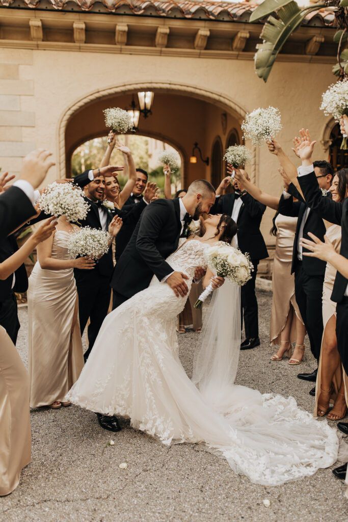 groomsmen in black tuxes and bridesmaids in cream dresses