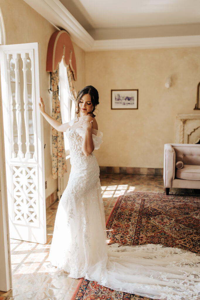 bride in off shoulder lace gown with train