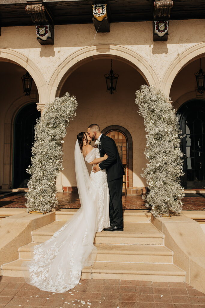 bride in lace gown and groom in black tux at Powel Crosley Estate