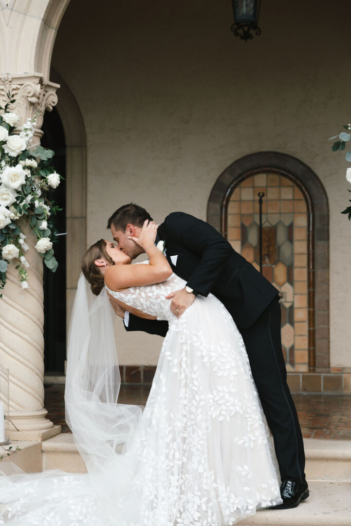 bride in floral lace wedding gown and groom in black tux