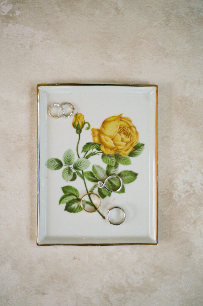 classic wedding jewelry in yellow rose dish