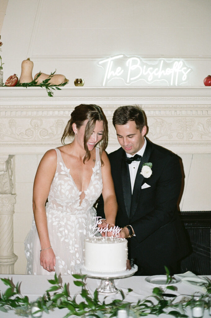 bride and groom cutting their classic white wedding cake