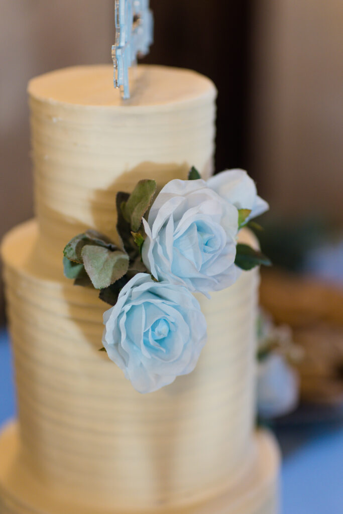 white wedding cake with blue floral accents