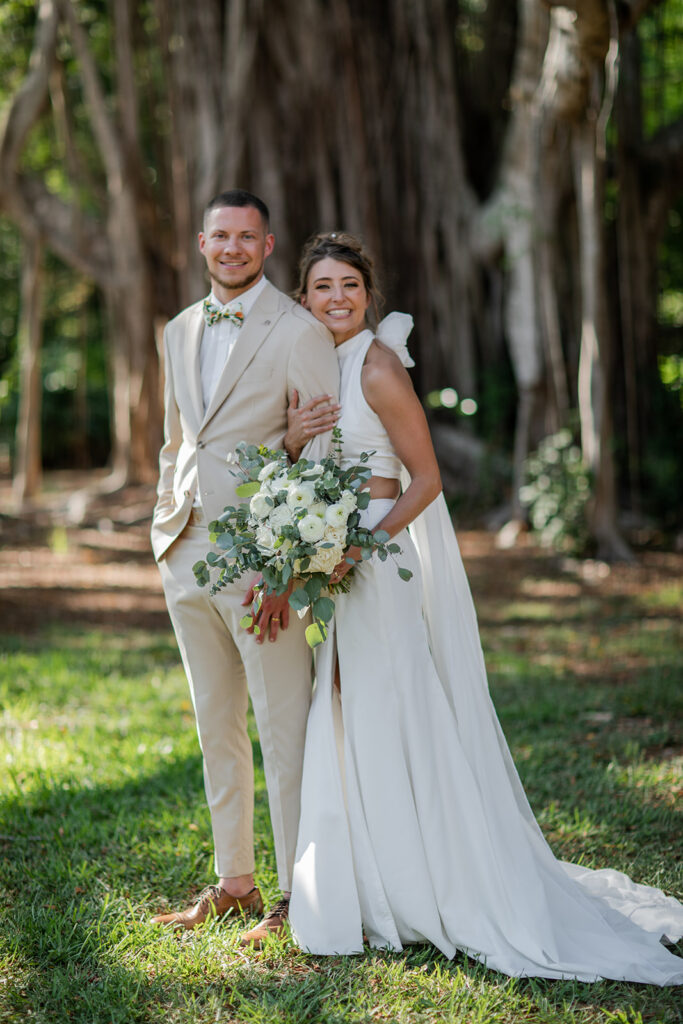 bride in two piece gown and groom in cream tux