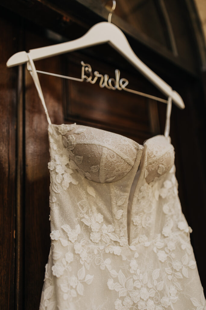 lace floral wedding gown on bride hanger