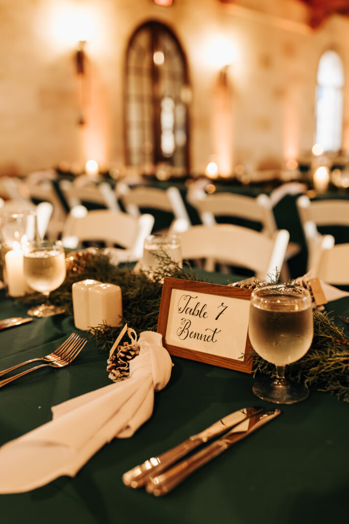 green and white tablescape with pine cone accents