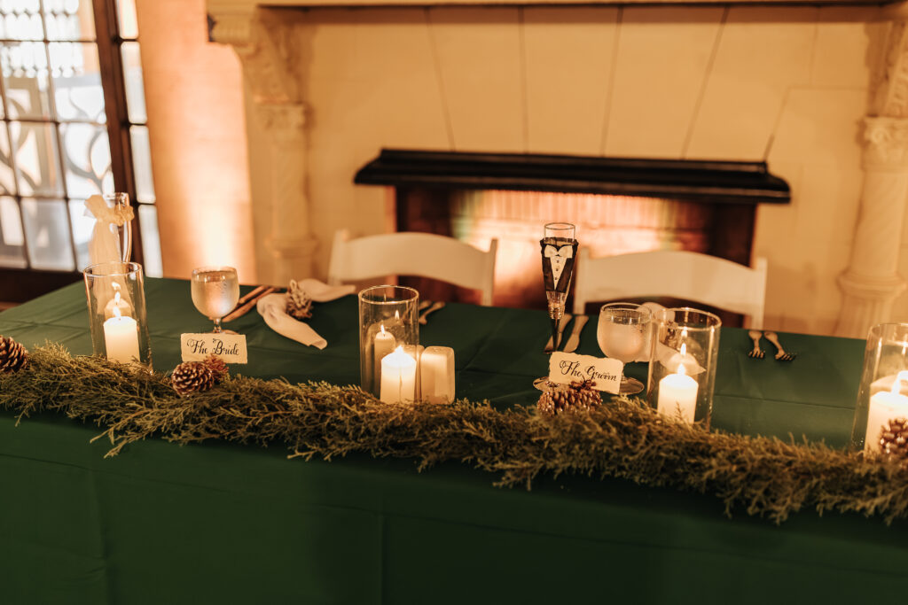 pine cone decorated sweetheart table at wedding