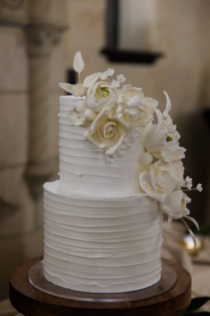 classic white wedding cake with floral accents