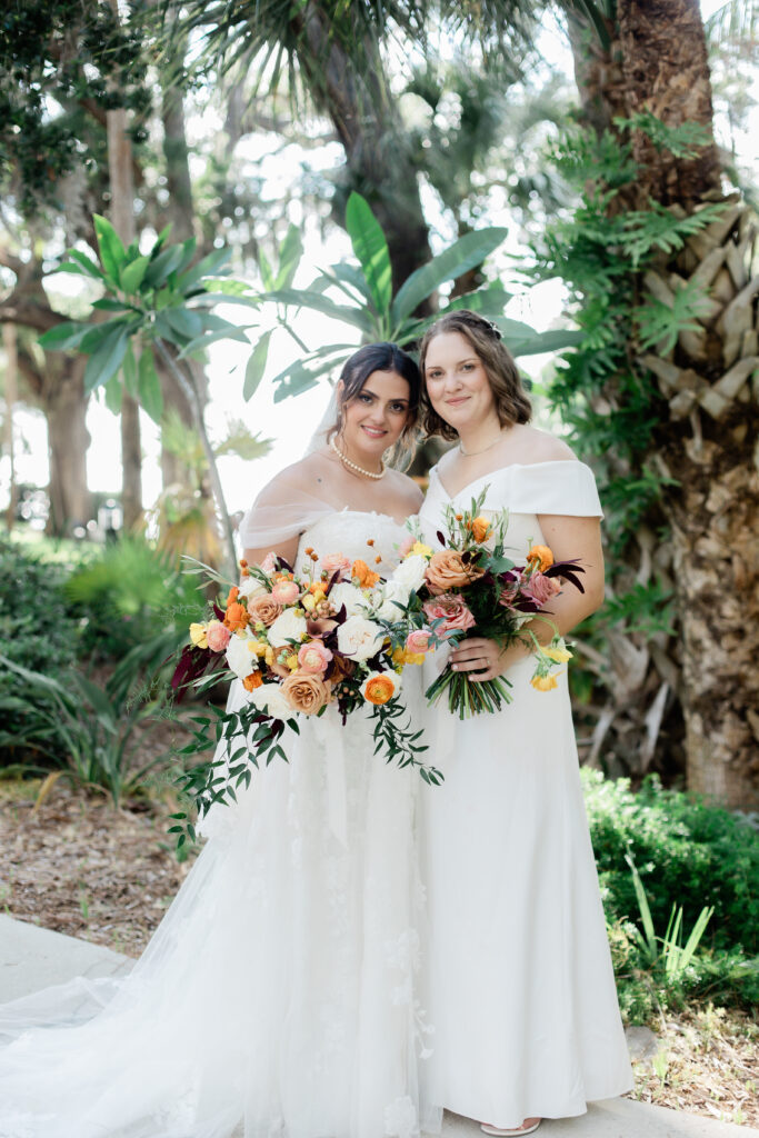 brides with off shoulder gowns and colorful bouquets