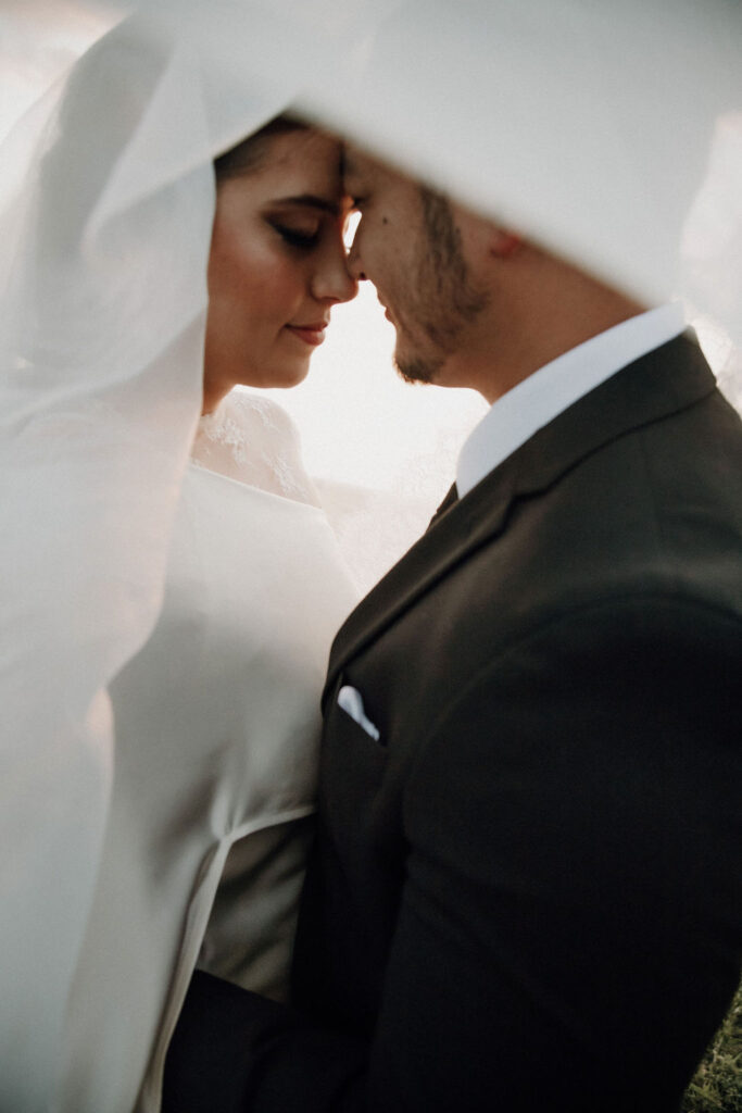 bride and groom portraits with veil