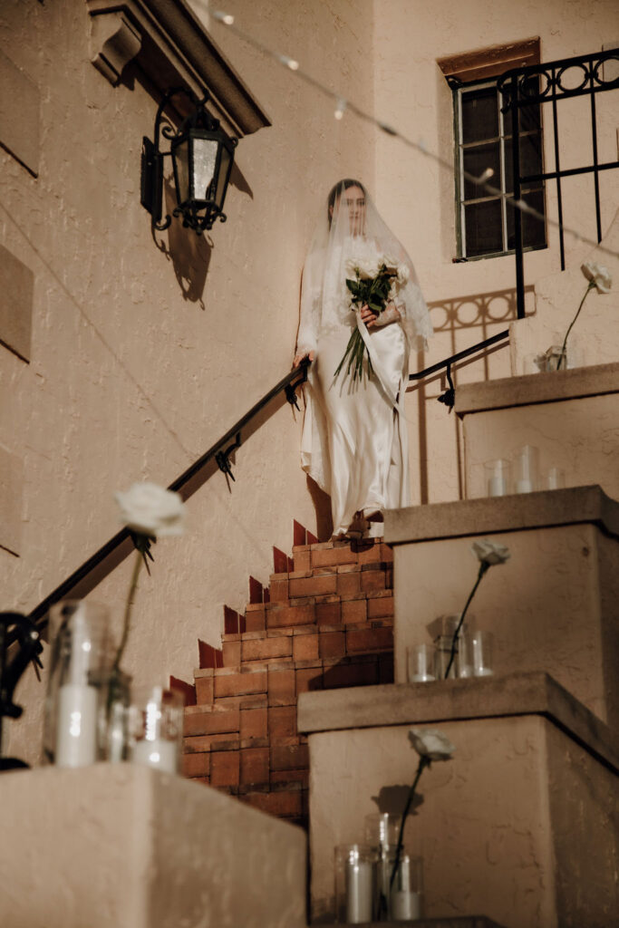 bride coming down decorated stairs at Powel Crosley Estate