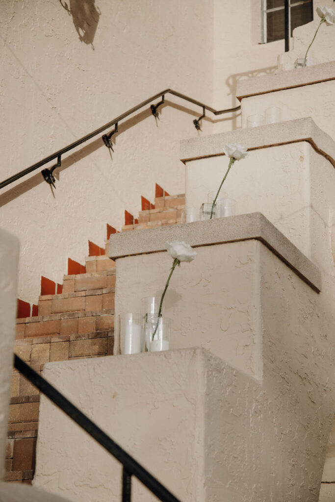 stair aisle decorated with white roses and candles