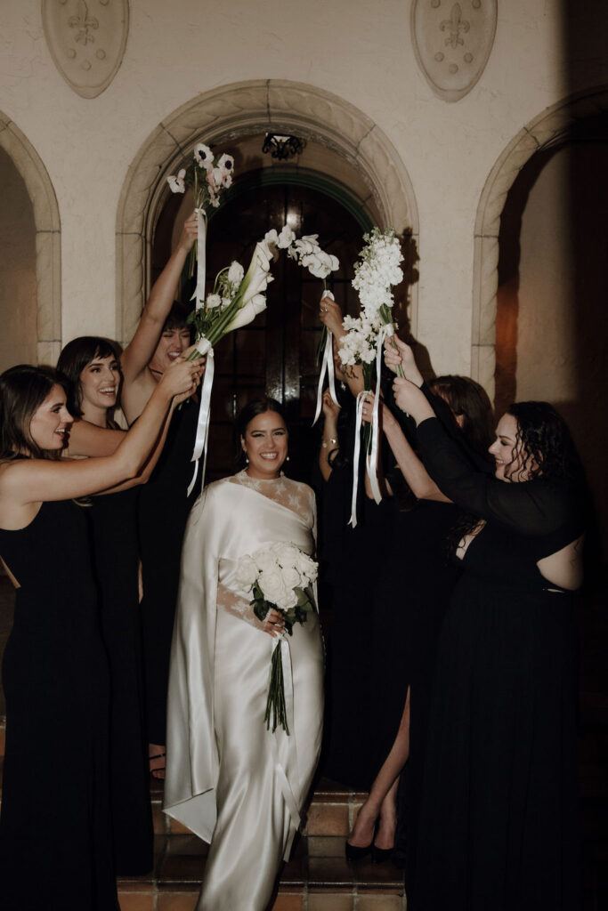 bridesmaids in black dresses and white bouquets