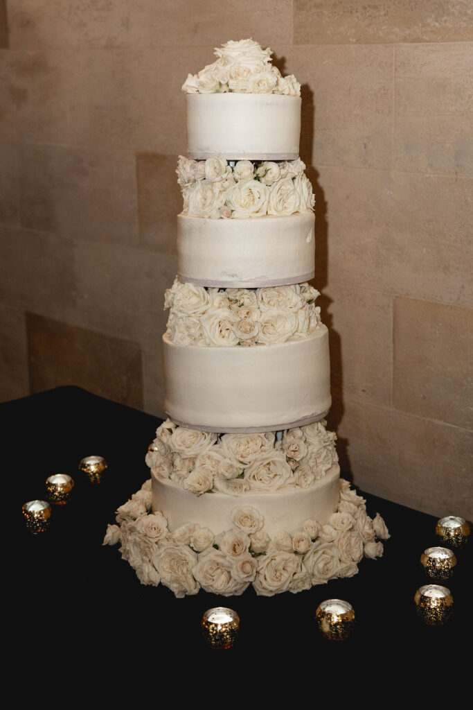 4-tiered white wedding cake with floral layers