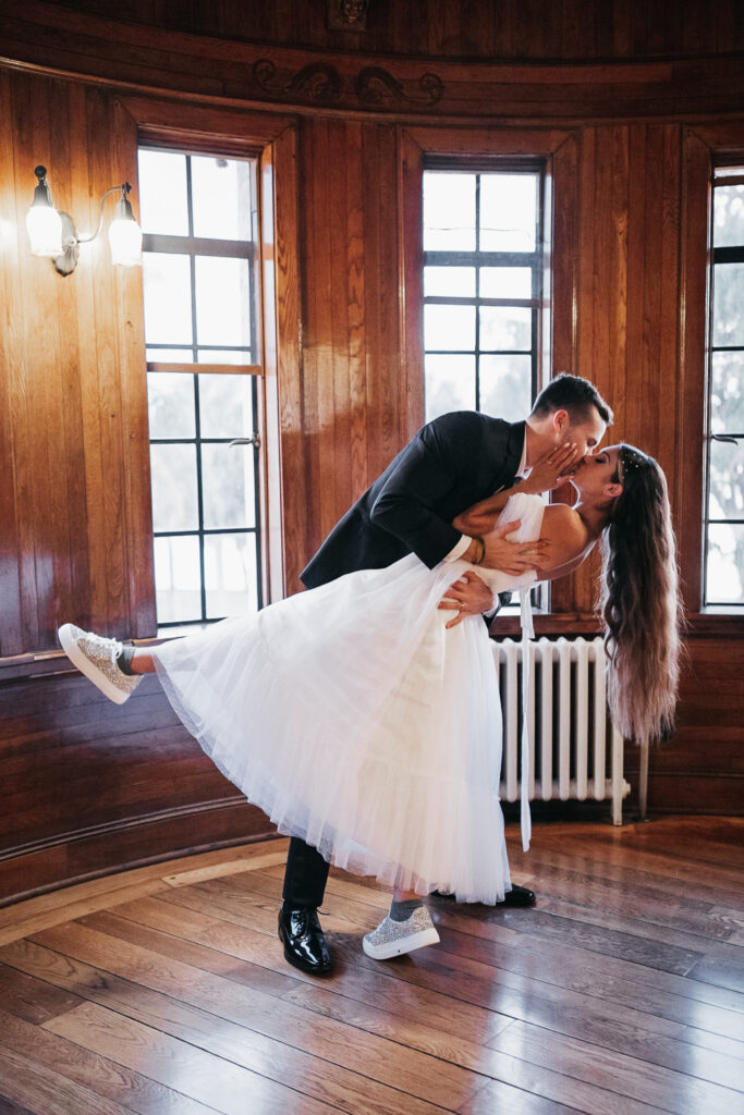 groom dipping bride in portraits