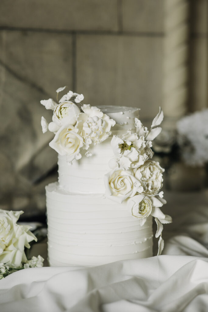 classic white wedding cake with floral accents