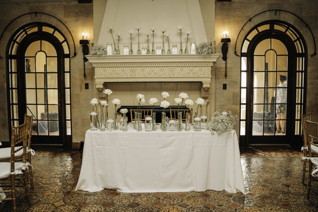 wedding sweetheart table decorated with white roses and baby's breath