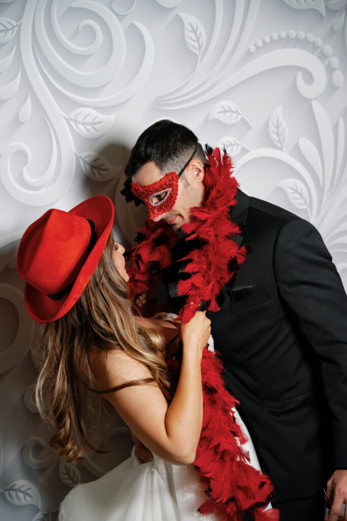 bride and groom in red photo accessories