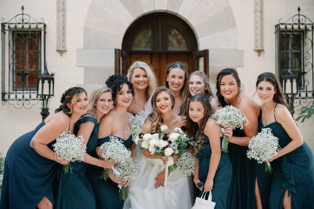 bridesmaids in teal dresses with baby's breath bouquets