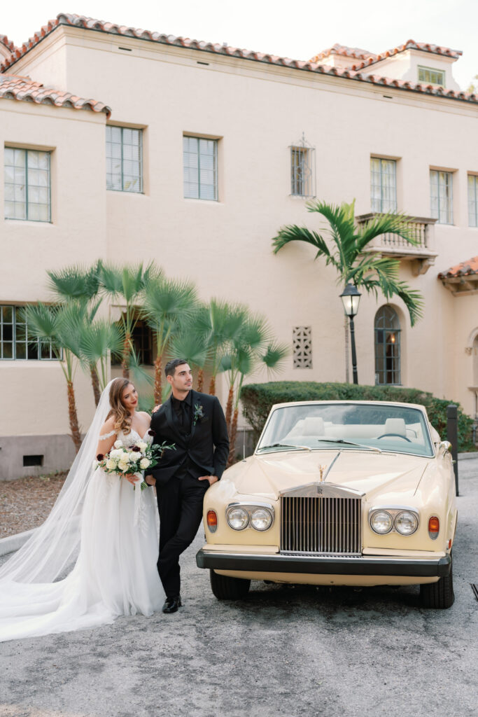 bride and groom with classic car